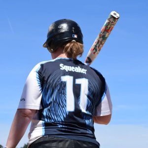 Softball player shouldering her bat